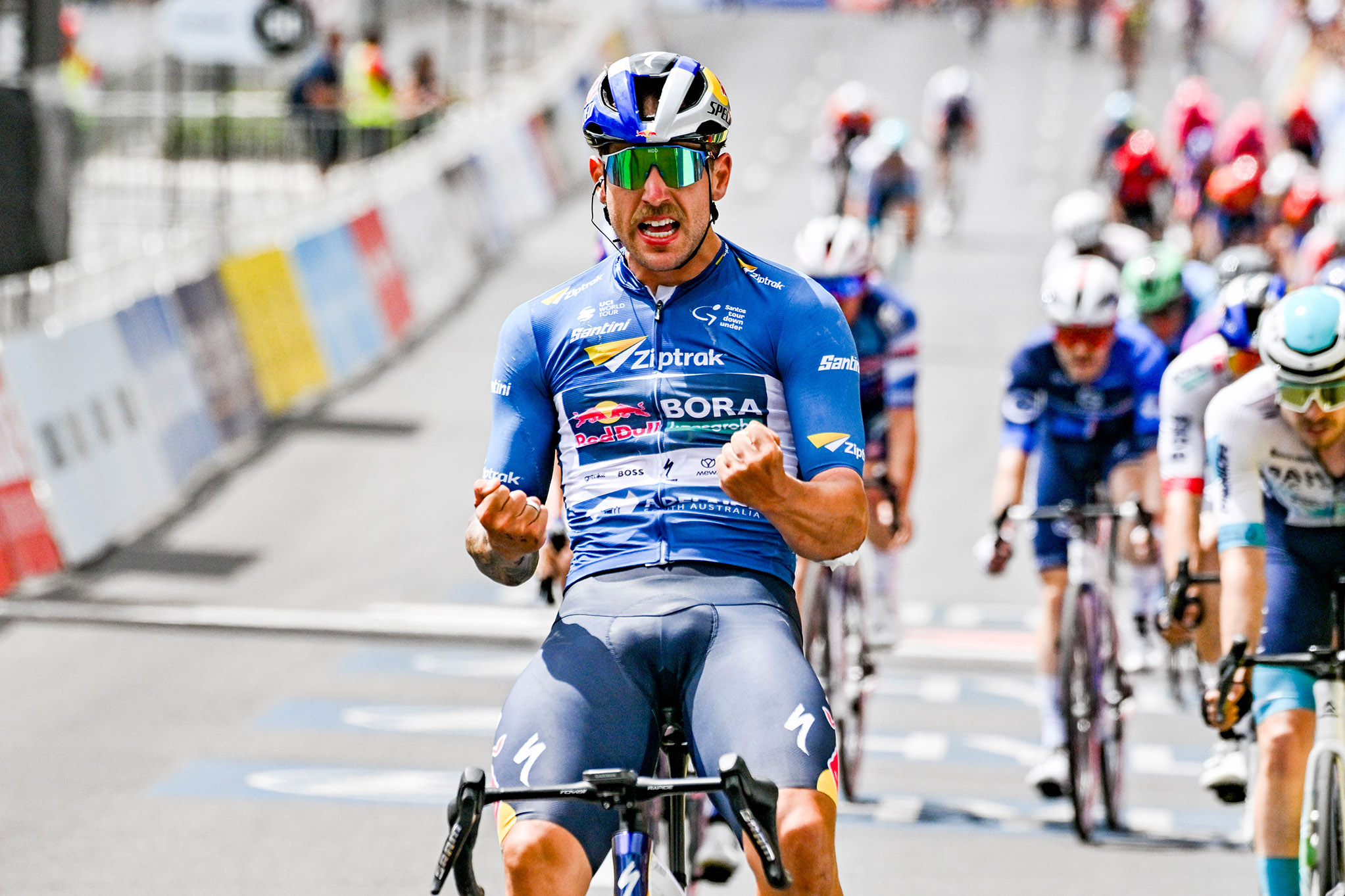 Sam Welsford celebrating the winning of the Tour Down Under 2025 wearing a Ziptrak sponsor kit.